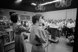 [Women lead churchgoers in song, 5]