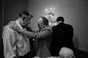 [Two men pray during church service, 1]