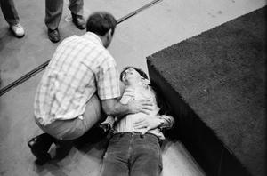 [Atlanta man lies on floor during church service]