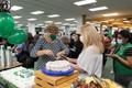 Photograph: [Dean Diane serving cake to Jodi Rhinehart-Doty]