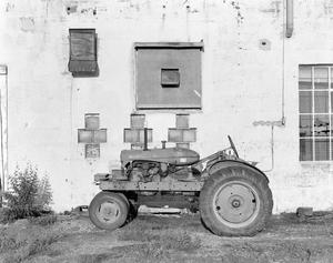 [A tractor parked in front of a building]