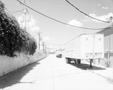 Photograph: [An alley behind a grocery store]