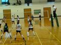 Primary view of [UNT volleyball team faces Tulsa opponents on the court, 2]