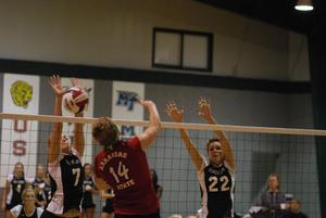 [Marelle Lempets and Brittany Brown attempt to block spike by Taylor Coughlin]