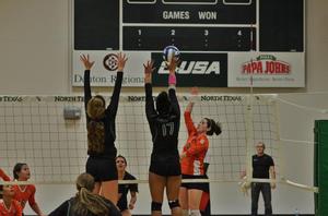 [Holly Milam and Camille Cherry attempt to block hit by Dayana Rios]
