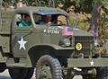 Photograph: [Men drive military vehicle at 2011 Homecoming Parade]