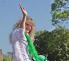 Photograph: [Woman waves at 2012 Homecoming Parade]