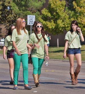 Primary view of object titled '[Young women walk 2012 Homecoming Parade]'.