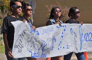 Primary view of object titled '[Zeta Phi Beta members carry banner at 2012 Homecoming Parade]'.