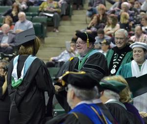 [Jerry Thomas presents Master of Education degree to graduate]