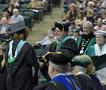 Photograph: [Jerry Thomas presents Master of Education degree to graduate]