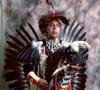 Photograph: [An Indigenous American in traditional black and red powwow clothing,…