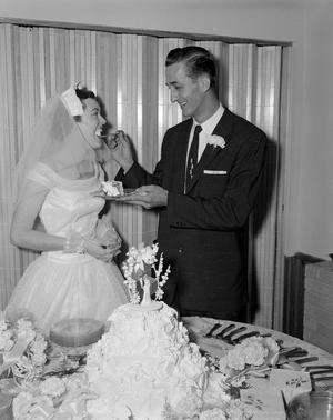 Primary view of [James Alan Wharton feeding cake to Lajean Valentine Hitch]