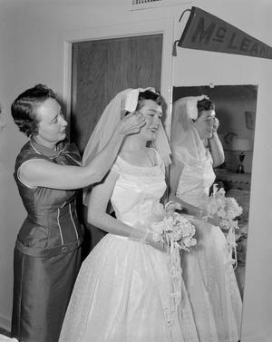 [Marjorie Lee Hitch putting the veil on her daughter's head, 2]