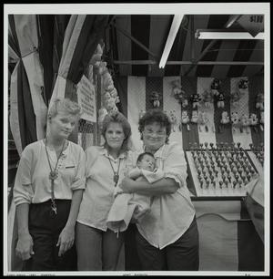 [Three women who are working at the state fair]