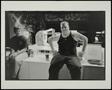 Photograph: [Ttwo men sitting on washing machines in a laundromat]