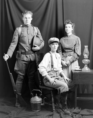 [Three actors posing in their costumes]