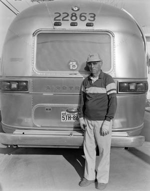 [A man standing in front of the rear of an airstream]