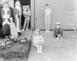 Photograph: [Five kids posing in front of a house's driveway]