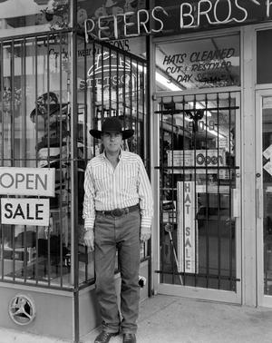 [A man standing in front of the Peters Bros store]