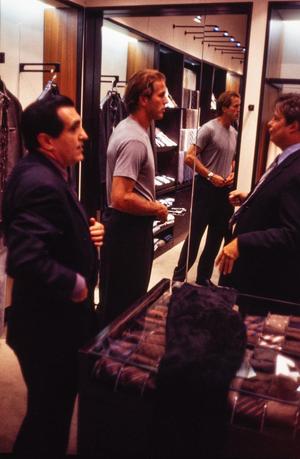 [A tailor, Mike Modano and a sales associate in a men's shop]