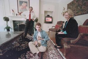 [Michael Rowlett and his parents Tracy and Jill in their living room, 2]
