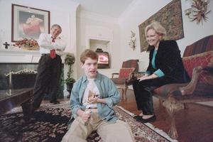 [Tracy and Jill Rowlett looking to their son Michael in their living room, 2]