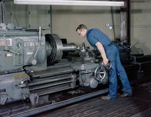 [Man using a LeBlond engine lathe at Oil States Rubber Co.]