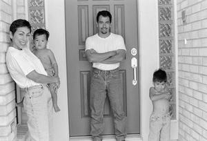 [Fred, Diana and their two sons posed outside the front door]