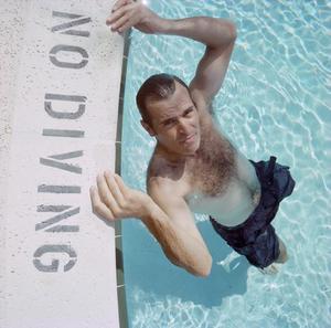[A man posing in a swimming pool]