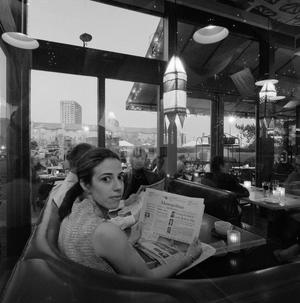 [A Woman Dining at a Restaurant]