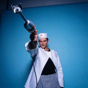 [Chef Enrique Granados posing with an immersion blender]