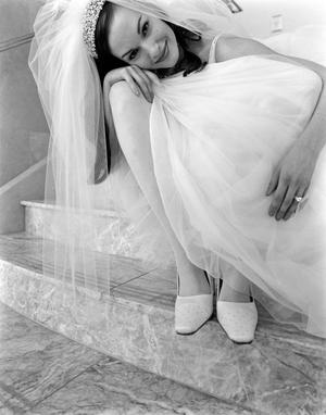 [Bridal model with her face resting on her knee]