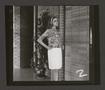 Primary view of [Woman posing in a pleated skirt and abstract-print top, 2]