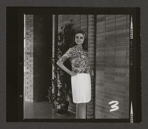 Primary view of object titled '[Woman posing in a pleated skirt and abstract-print top, 3]'.