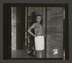 Primary view of [Woman posing in a pleated skirt and abstract-print top, 3]