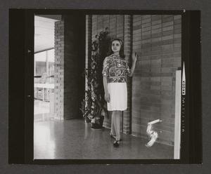 Primary view of object titled '[Woman posing in a pleated skirt and abstract-print top, 5]'.