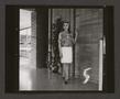 Thumbnail image of item number 1 in: '[Woman posing in a pleated skirt and abstract-print top, 5]'.