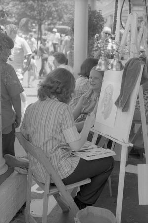 [A girl getting her portrait drawn at Six Flags Over Texas in Arlington, 1]