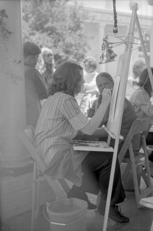 [A girl getting her portrait drawn at Six Flags Over Texas in Arlington, 3]