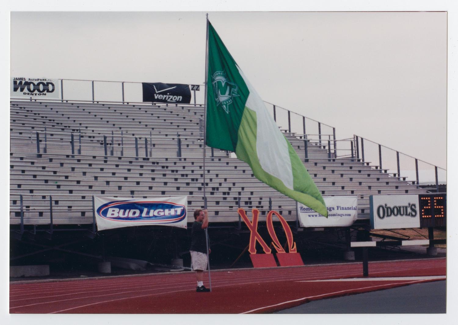 [A Talons member holding the UNT flag during the game