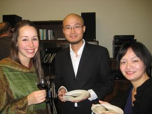 [Beixi Gao (right), Lejing Zhou (center), and a woman holding dishes and a wineglass]