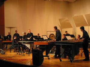 [A group of percussionists in black playing xylophones and drums onstage, 4]