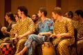 Thumbnail image of item number 1 in: '[Rows of men in patterned clothing sitting with percussion instruments]'.