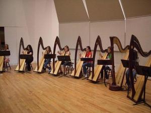 [A row of seven girls playing harps]