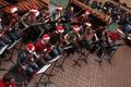 Photograph: [Two rows of people playing bassoons adorned with tinsel, 2]
