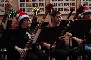 [Two rows of people playing bassoons adorned with tinsel, 4]