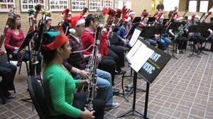 [Two rows of people playing bassoons adorned with tinsel, 7]