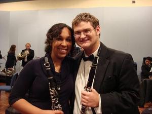 [A woman and a man posing with their clarinets]
