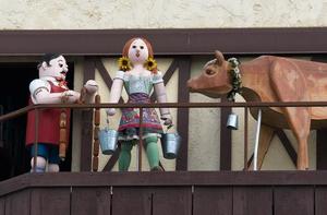 Primary view of object titled '[Charming Wooden Sculptors: A Rustic Delight at Fischer's Meat Market]'.
